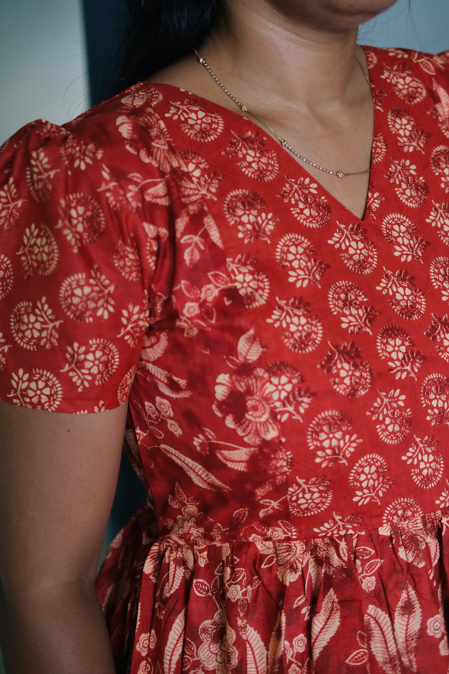 Close-up of the V-neckline and short puff sleeves on the feeding nighty for women.