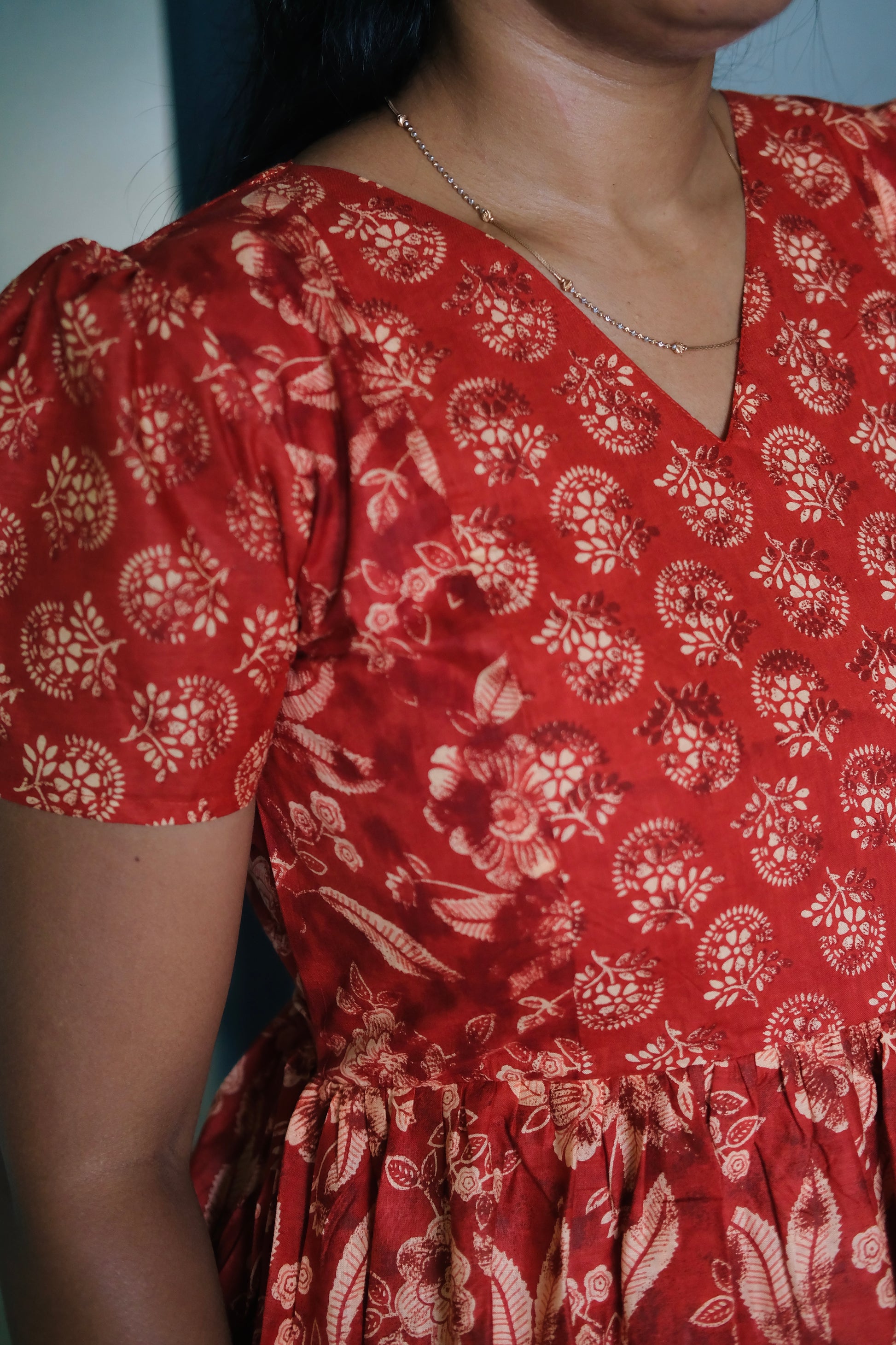 Close-up of the V-neckline and short puff sleeves on the feeding nighty for women.