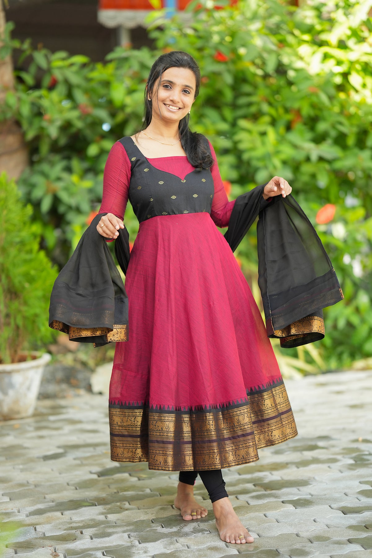 Red and black ethnic anarkali suit with traditional woven border
