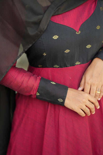 Close-up of black yoke and sleeve details on red cotton anarkali