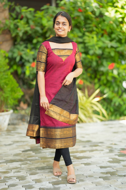 Model showcasing the elegant drape of the black dupatta with gold zari border paired with the red cotton kurti.