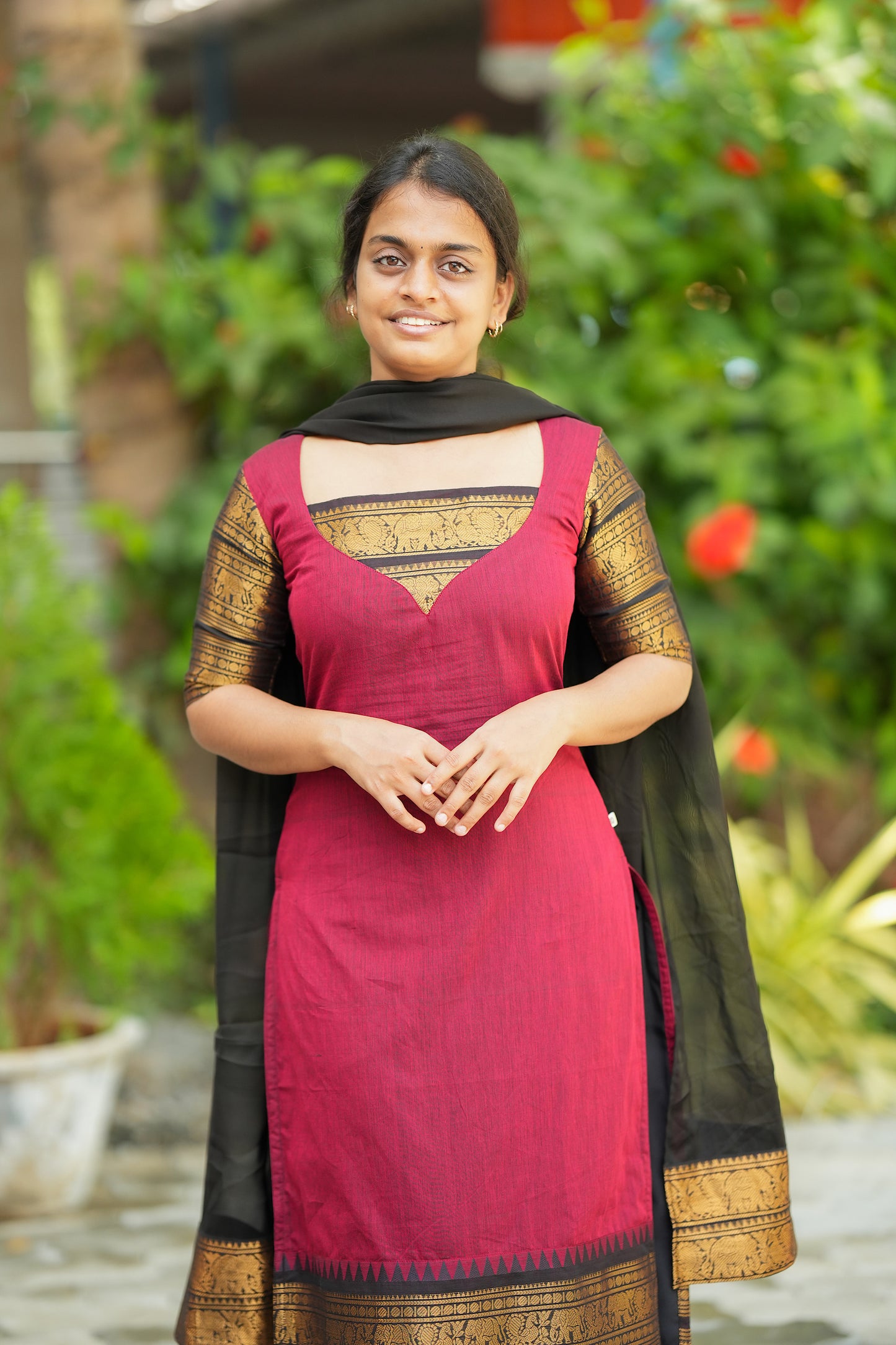 Front view of the Elamathi red cotton kurti set with dupatta highlighting the unique triangular yoke design.