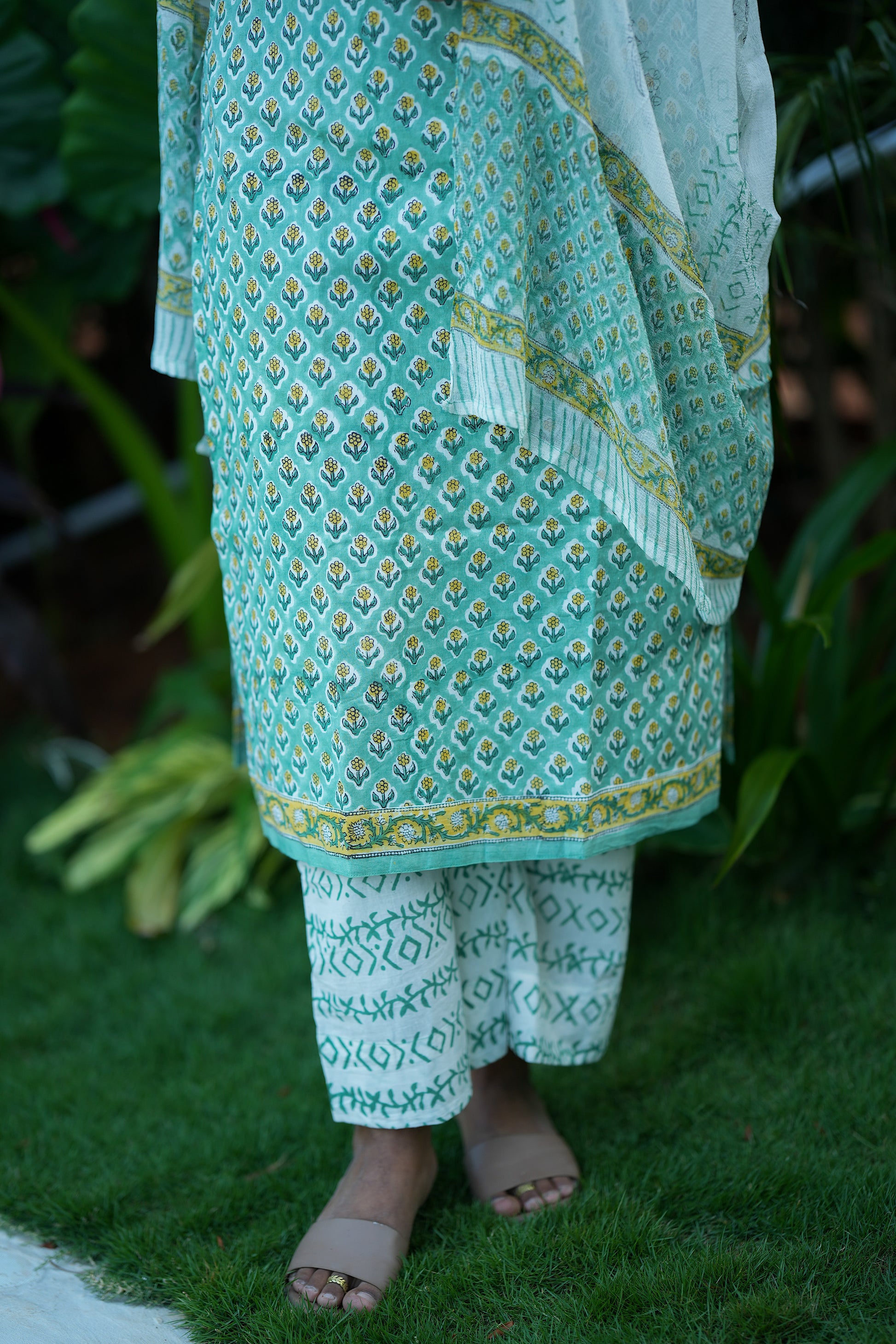 Close-up of the mint green block printed kurti hem and geometric printed pants.