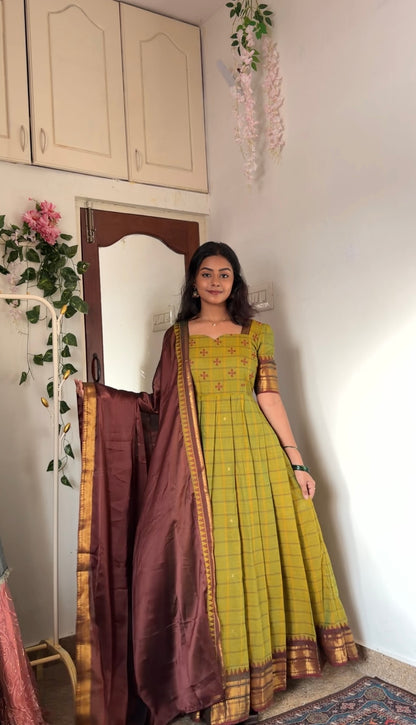 Close-up of the tea green anarkali dress and maroon dupatta with gold woven border