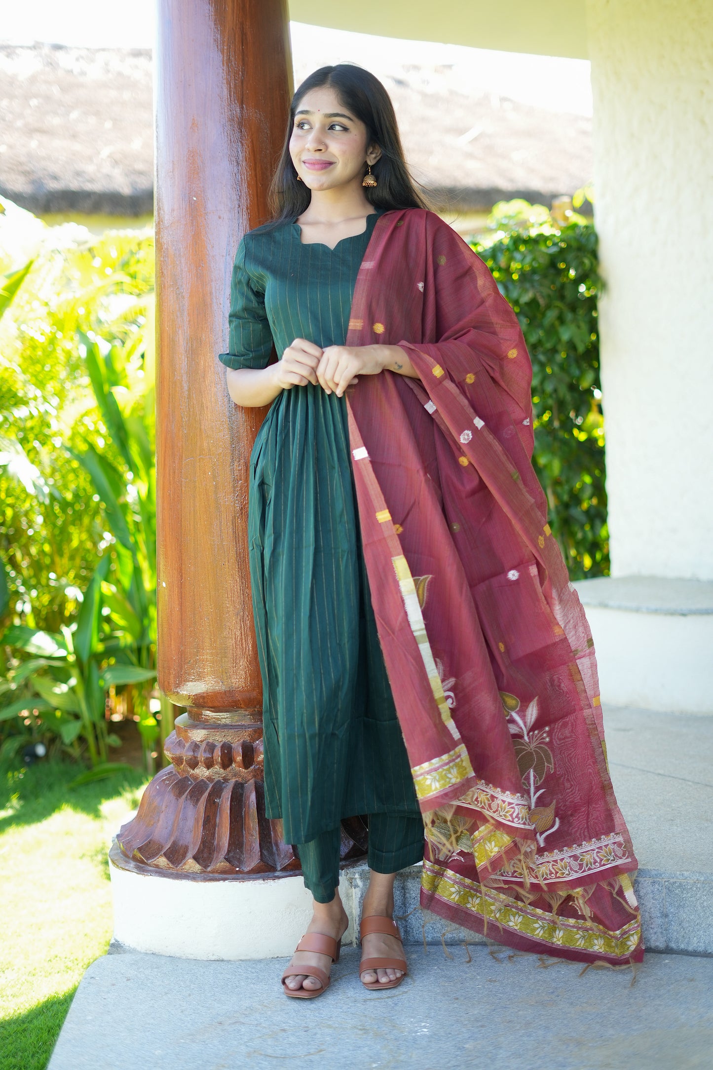 Bottle green raw silk kurta set with dupatta in a contrast maroon shade, featuring a gathered waist and notched neckline.