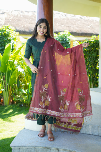 Full-length view of the bottle green suit set with the contrast maroon dupatta fully draped to show its gold borders and tassels.