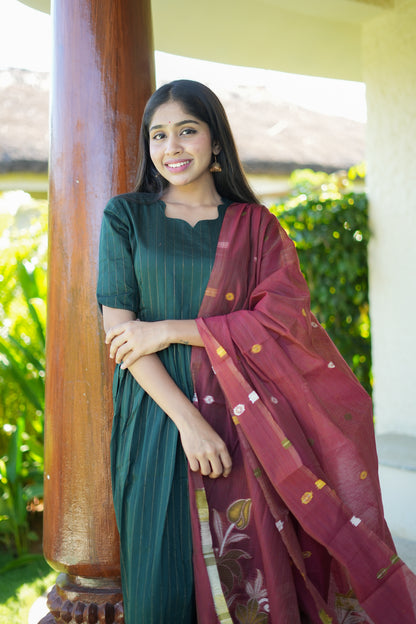 Front view of the bottle green silk kurta set with dupatta, highlighting the elbow-length sleeves and sweetheart neckline.