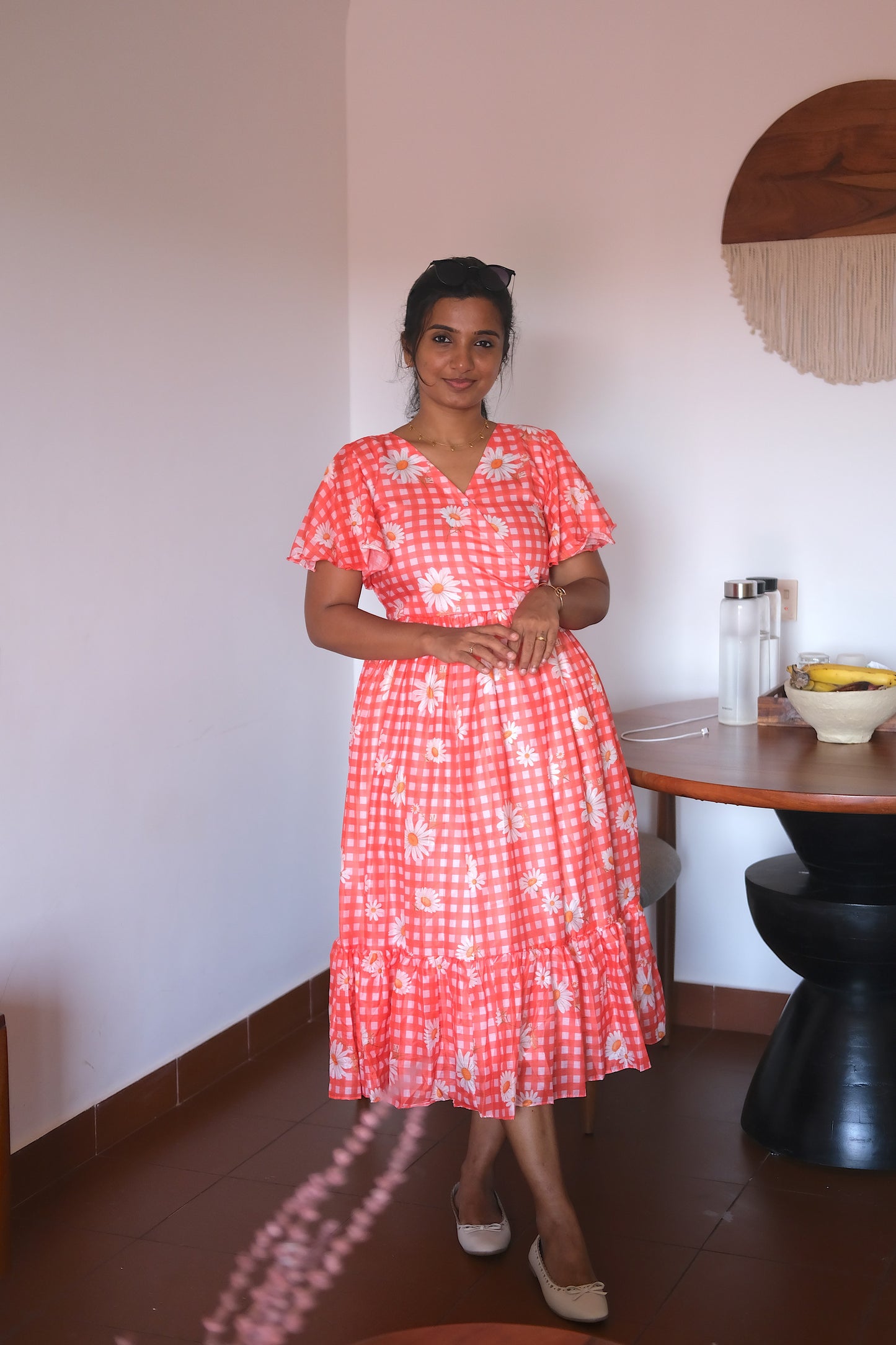 Full view of the coral floral print tiered cotton midi dress.