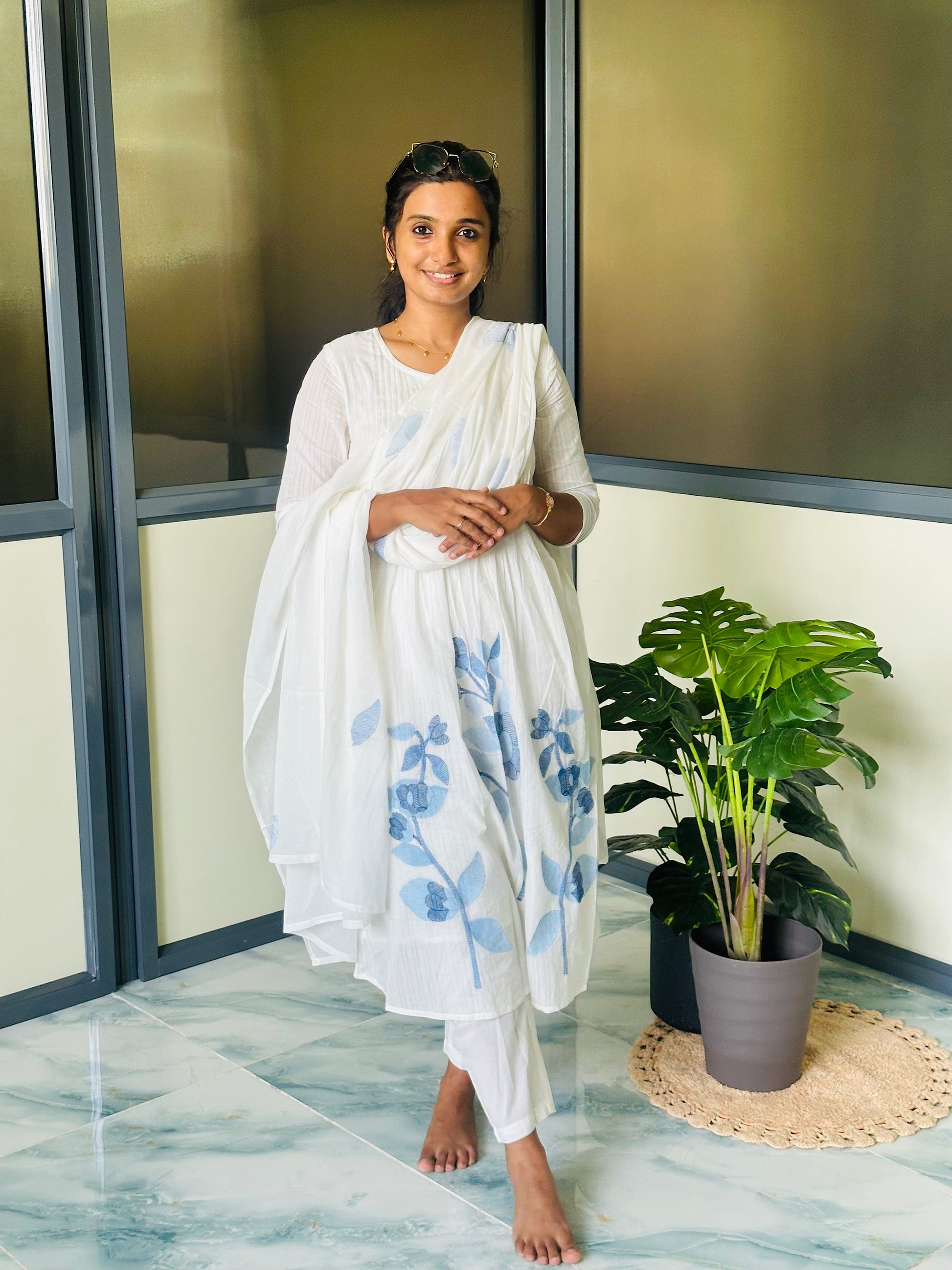 Pure mul cotton kurti set with dupatta draped over the shoulder, featuring delicate blue floral motifs