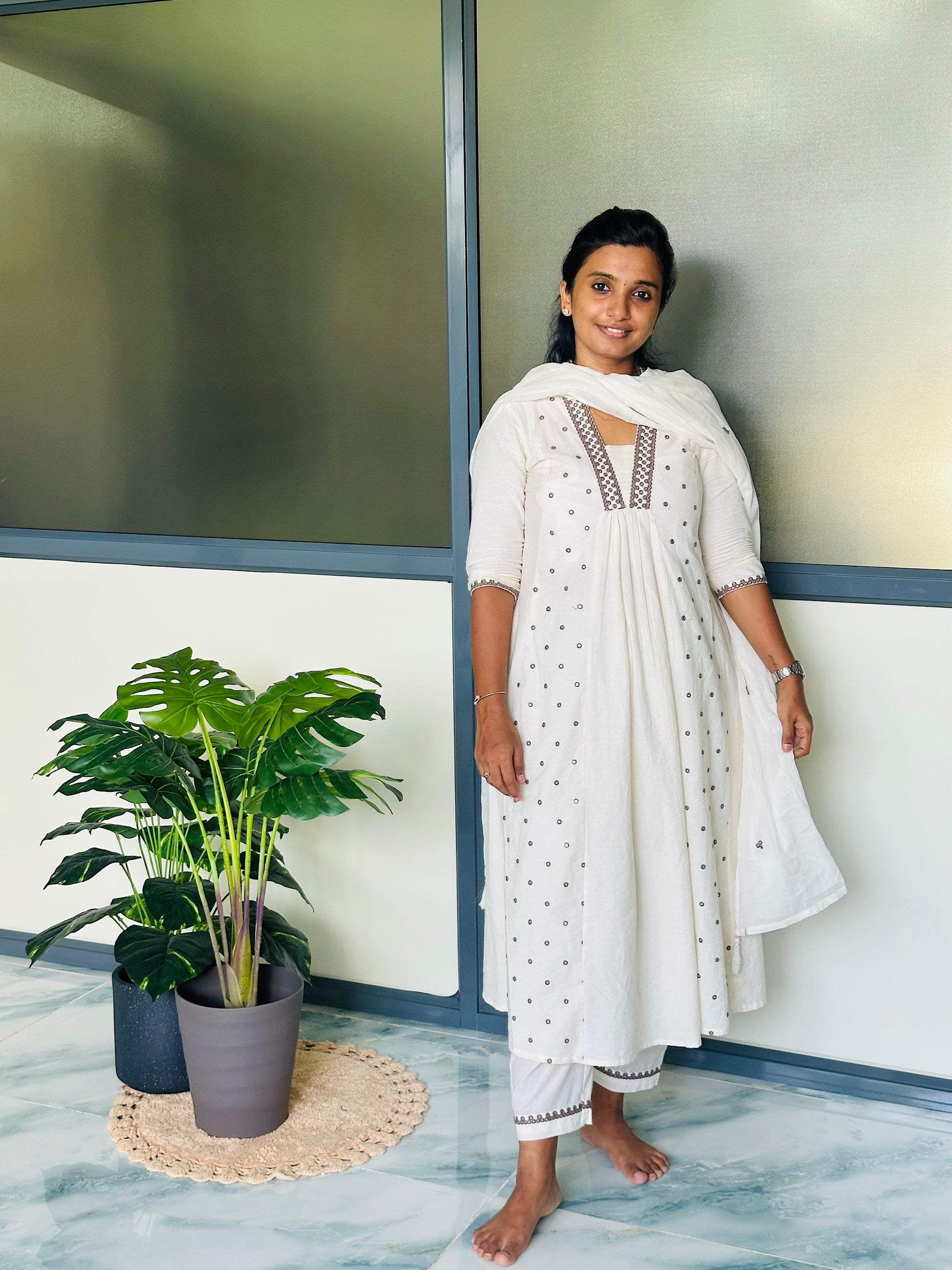 Close-up of mirror work detailing on off-white cotton kurti