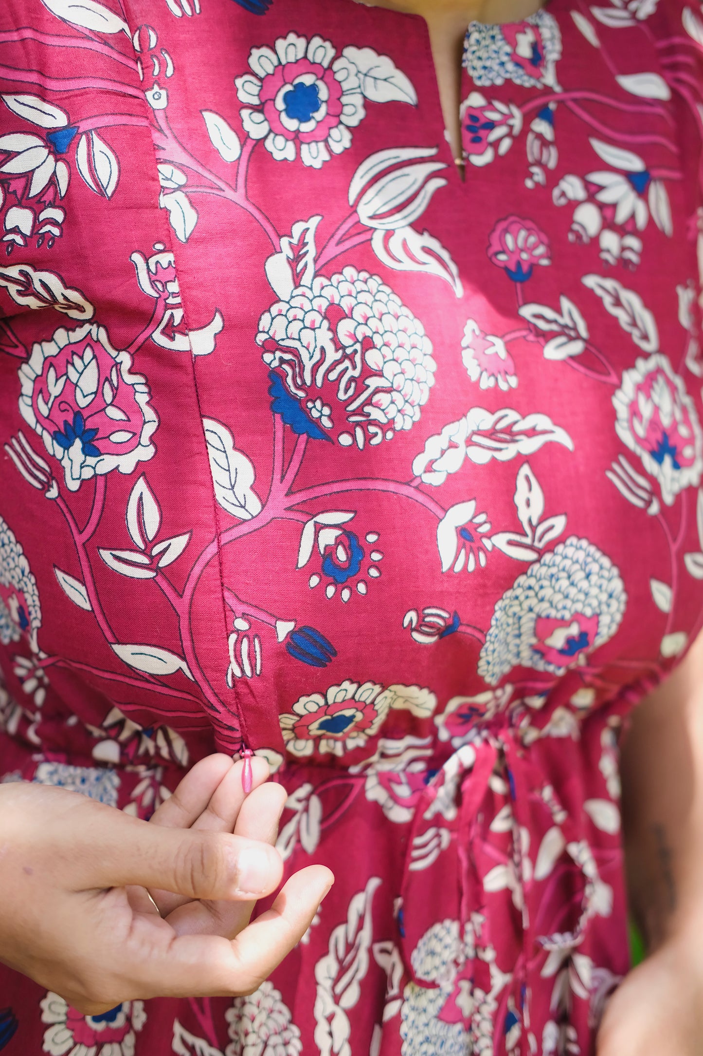 Close-up of the concealed zipper detail on the maroon printed cotton maxi dress