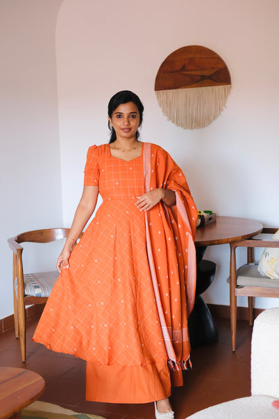 Pranika rust orange multiwear maxi dress styled as a 3-piece cotton anarkali suit set with a matching woven dupatta.
