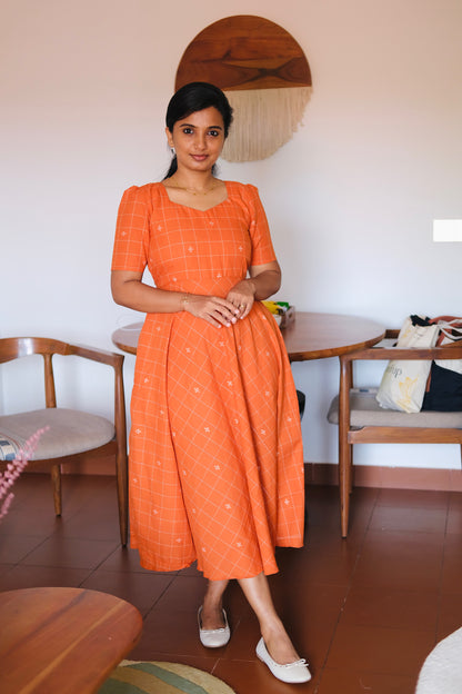 A-line rust orange patterned cotton midi dress with short puff sleeves and a sweetheart neck.