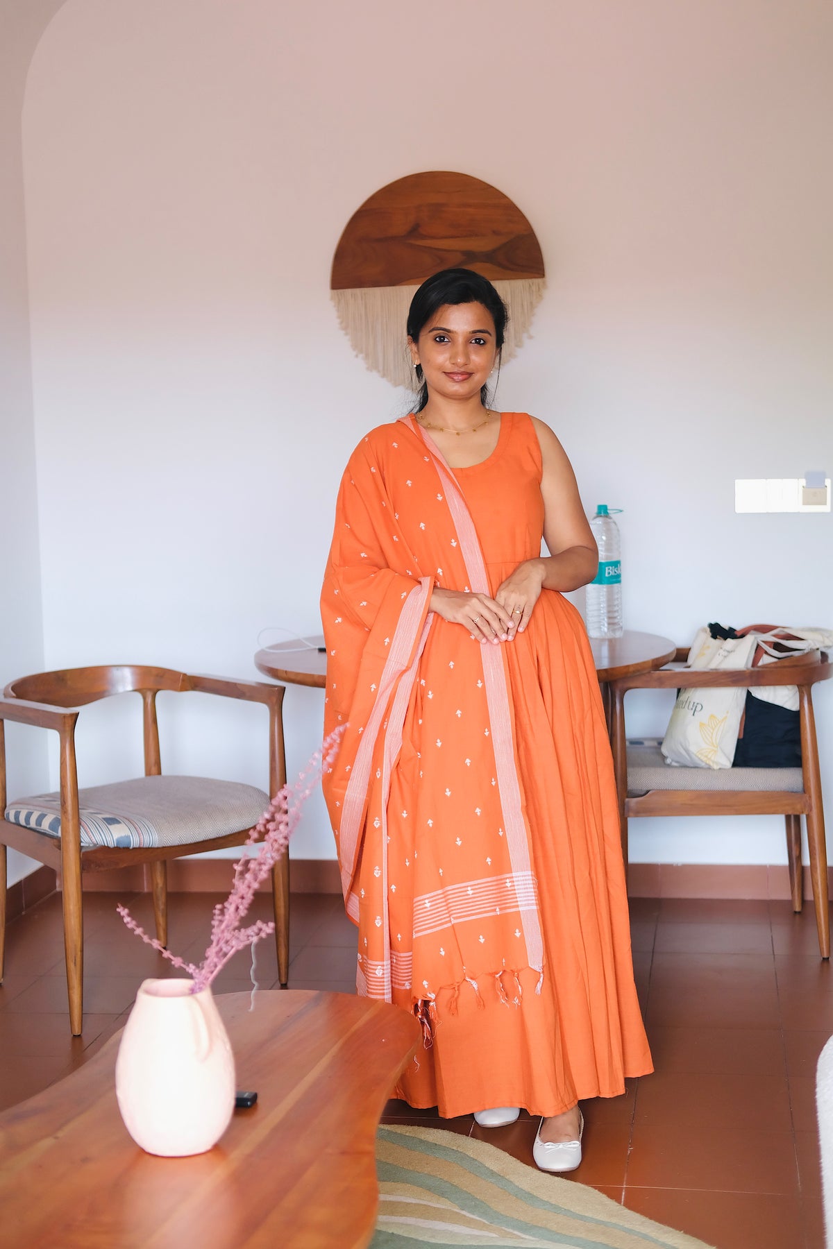 Sleeveless solid rust orange cotton maxi dress paired with a matching handloom dupatta.