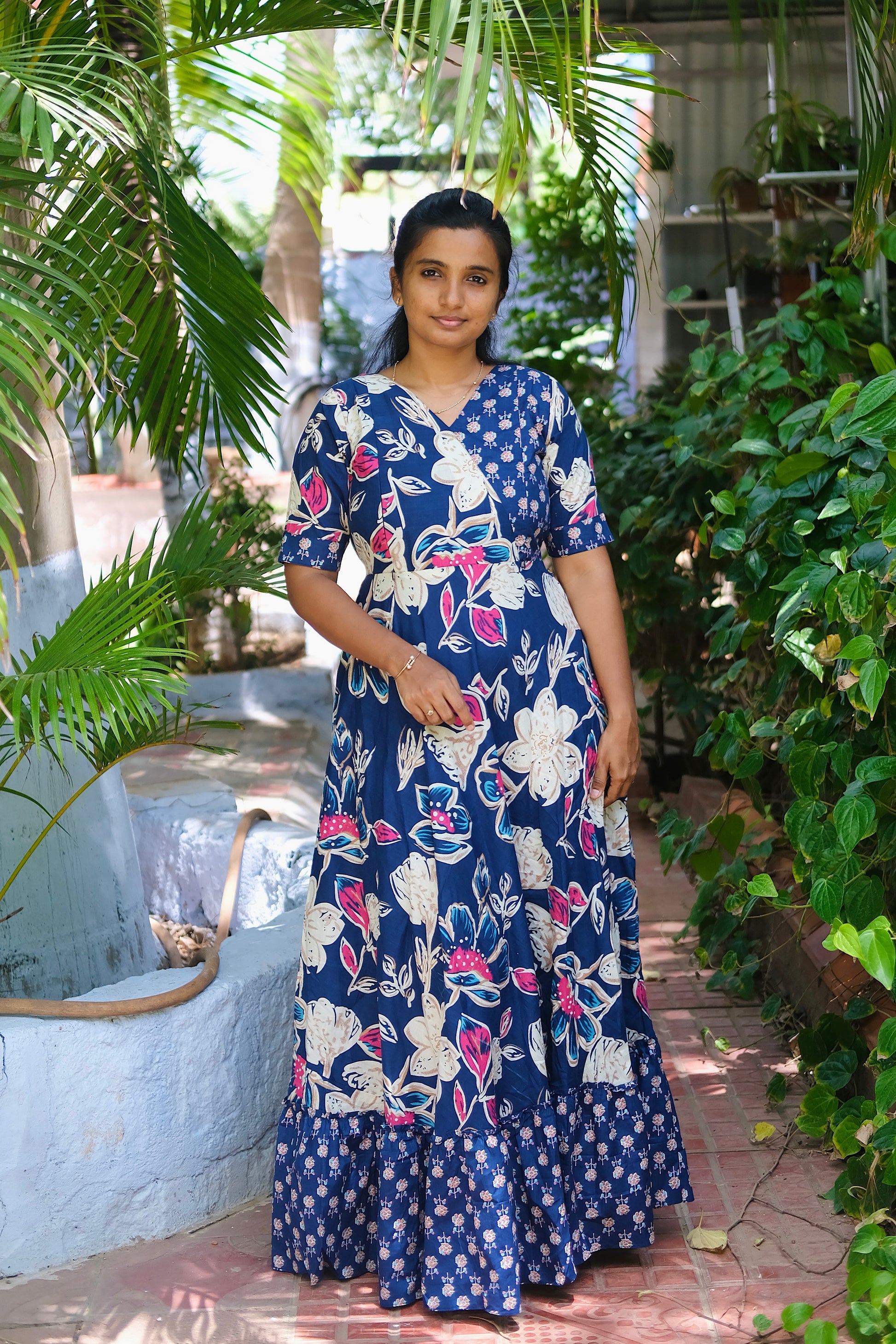 Full-length blue printed long dress featuring a flared skirt and V-neckline
