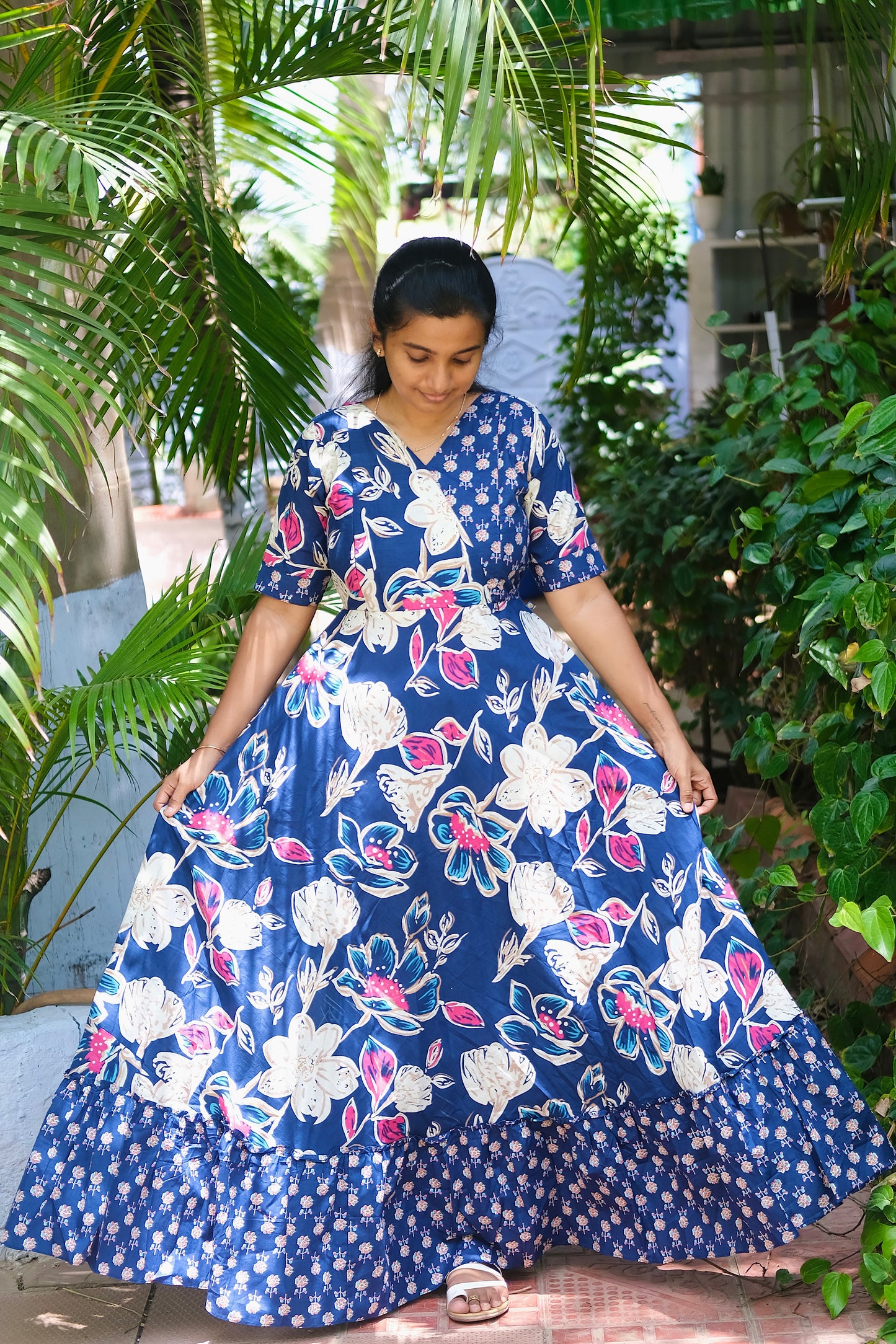 Flared blue cotton maxi dress showing the wide sweep and contrasting floral border