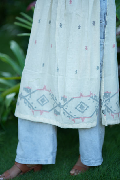 Detailed view of the geometric border print at the hem of the off-white cotton kurti