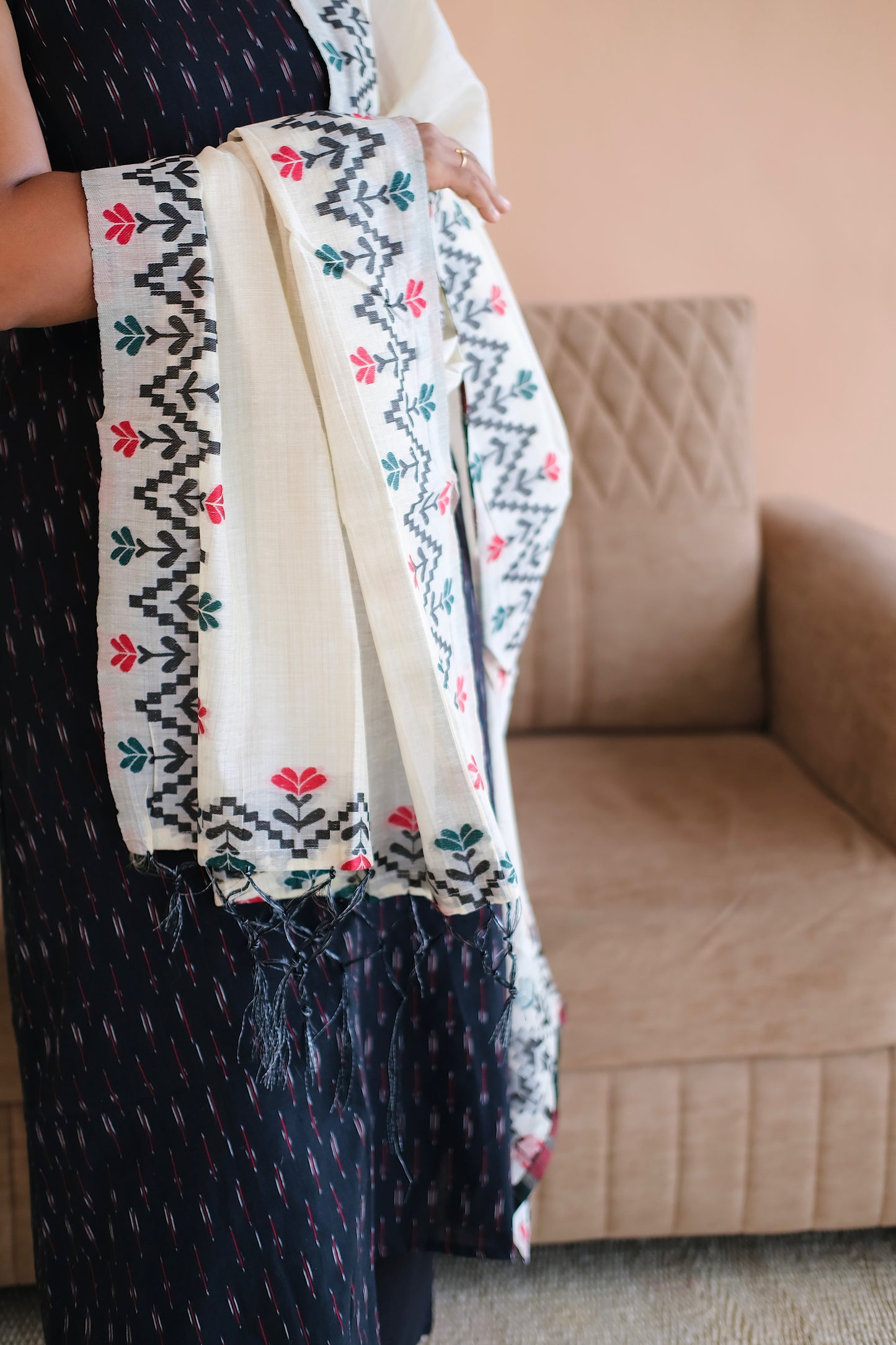 Detailed view of the woven patterns on the dupatta paired with the black ikat kurti