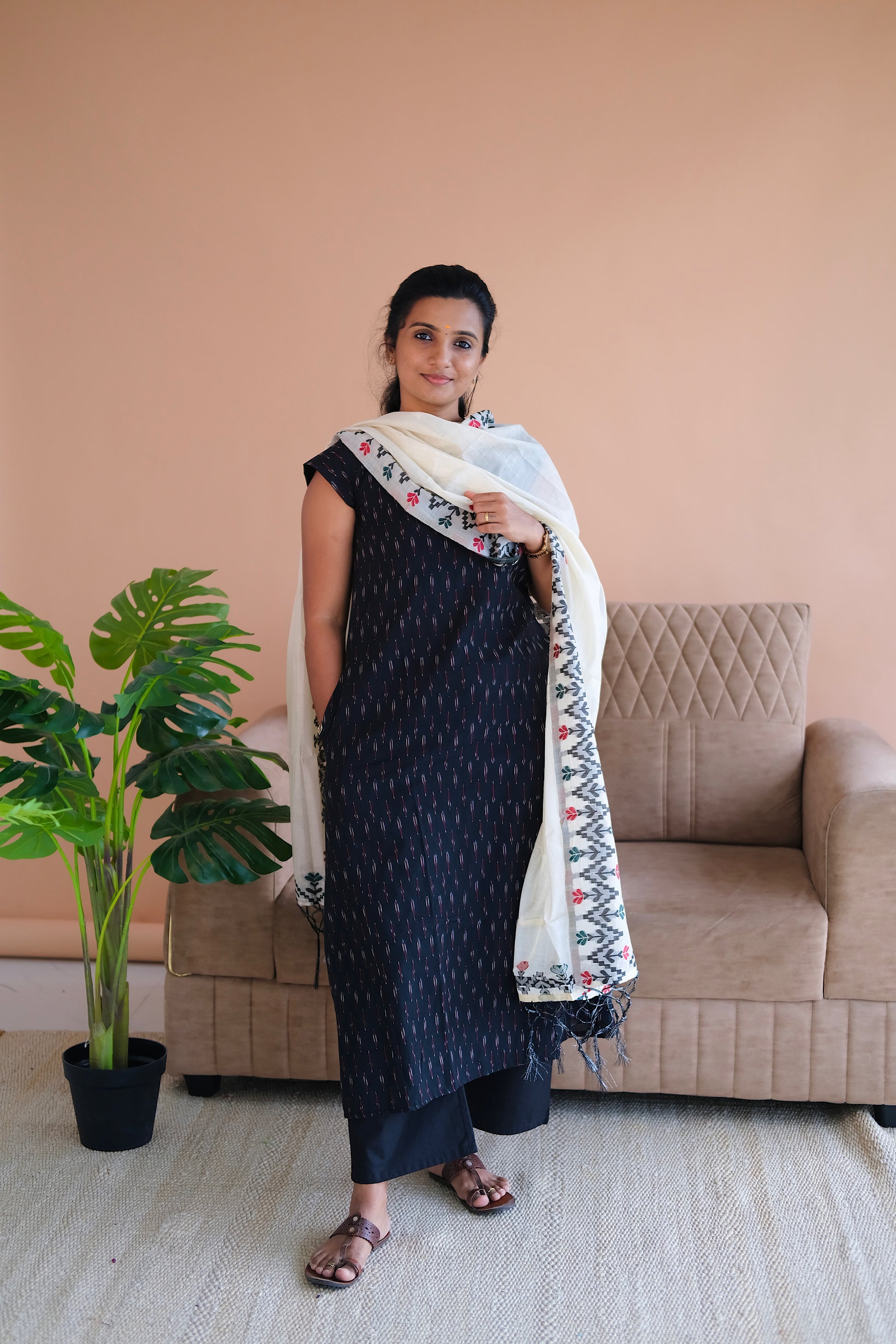 Full-length view of the black A-line kurti with side pocket and cap sleeves