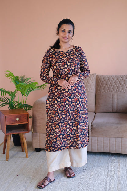 Full-length view of the elegant black printed cotton straight kurti paired with cream trousers.