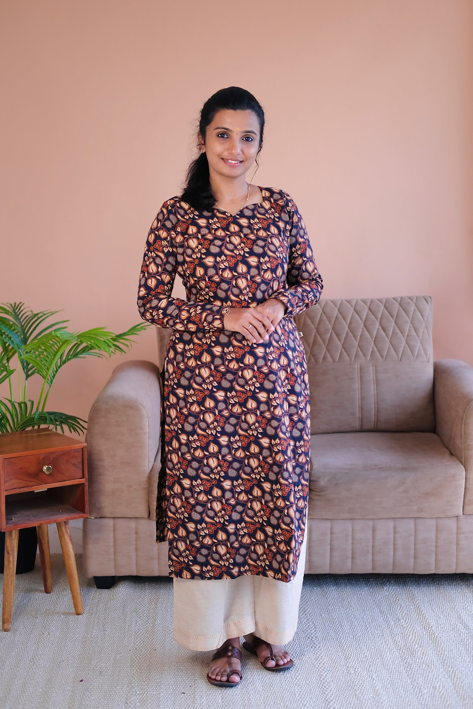 Front view of Tanisha black printed cotton straight kurti with full sleeves and traditional block print motifs.