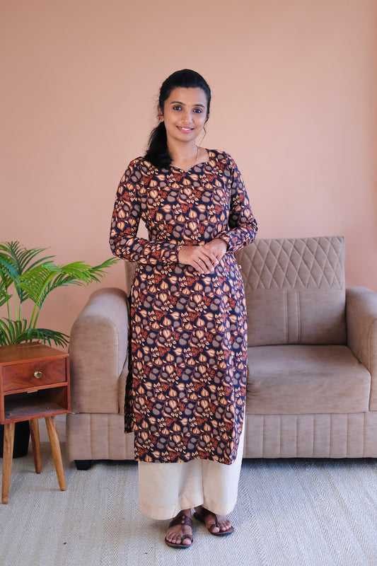 Front view of Tanisha black printed cotton straight kurti with full sleeves and traditional block print motifs.