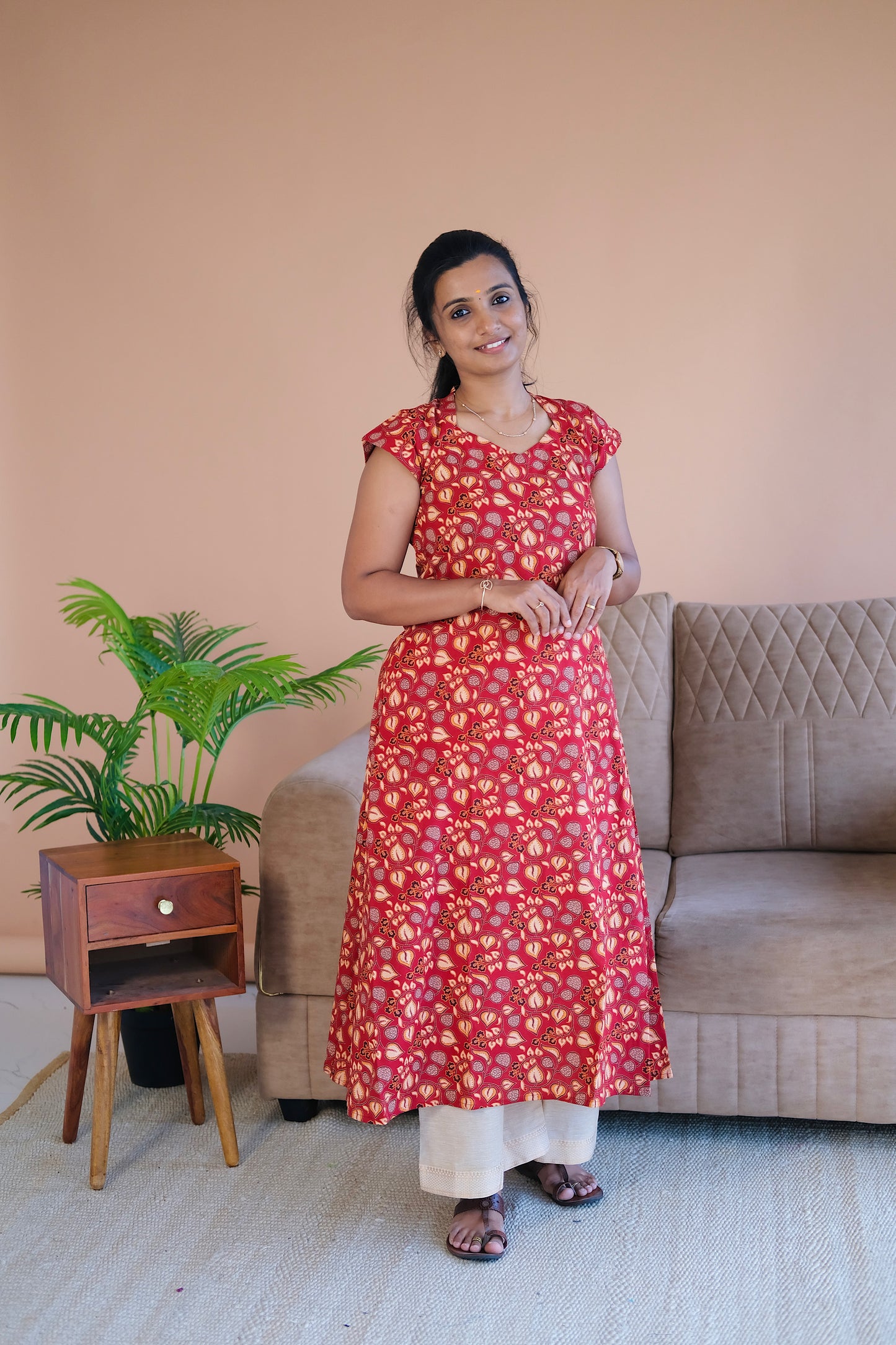 Red printed cotton a line kurti paired with cream pants