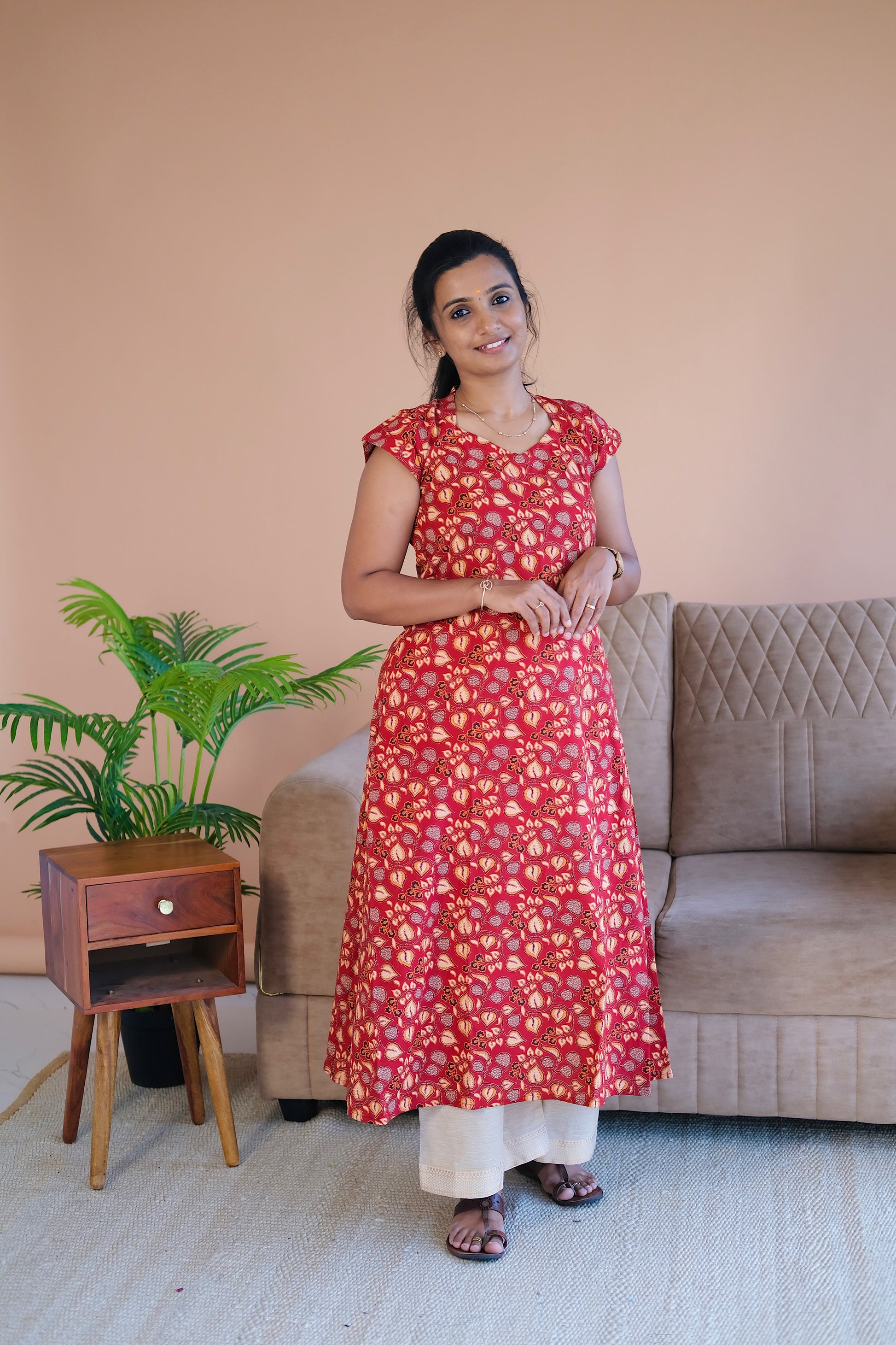 Red printed cotton a line kurti paired with cream pants