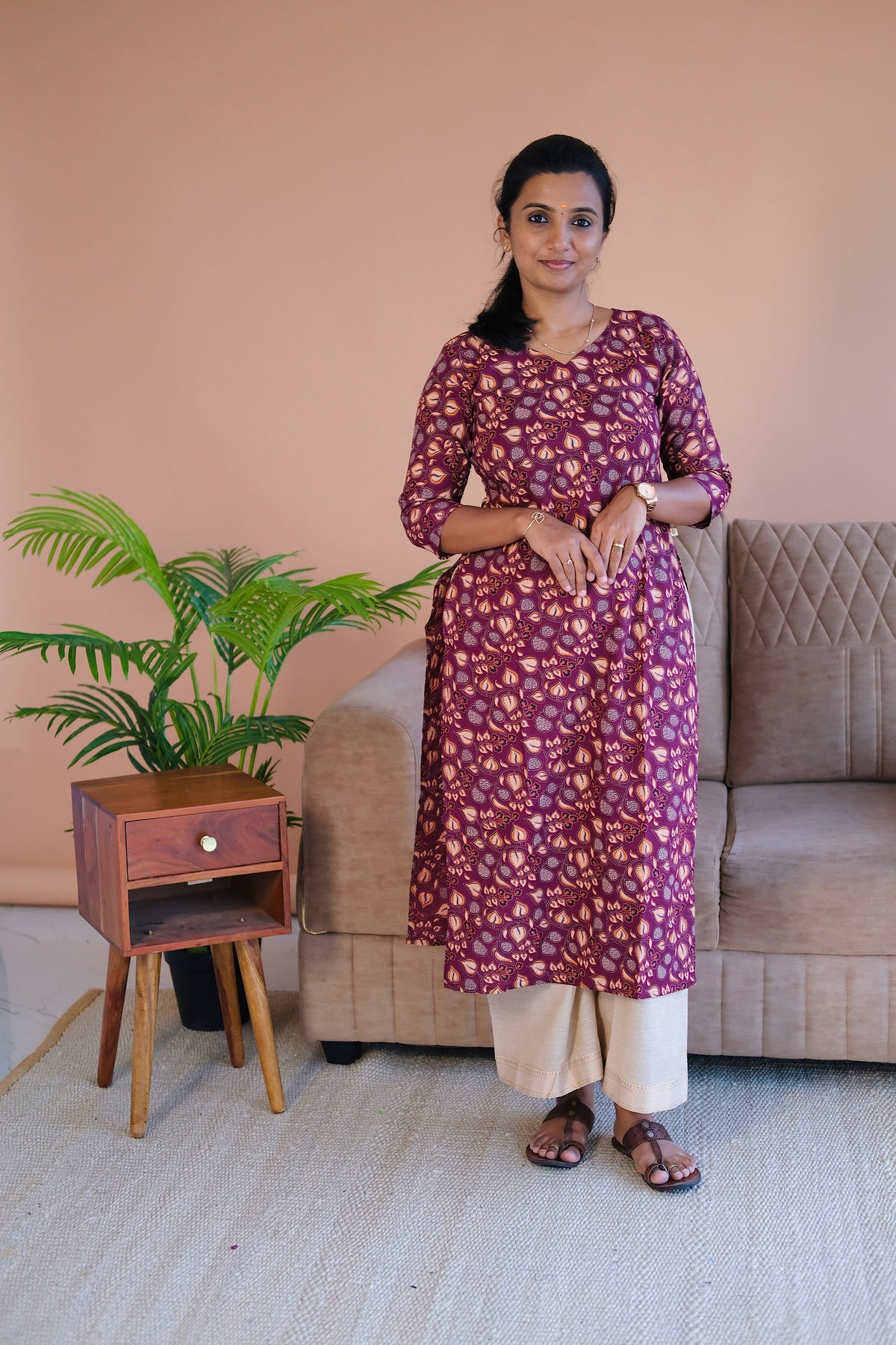 Straight fit plum printed cotton kurti showing side slit details