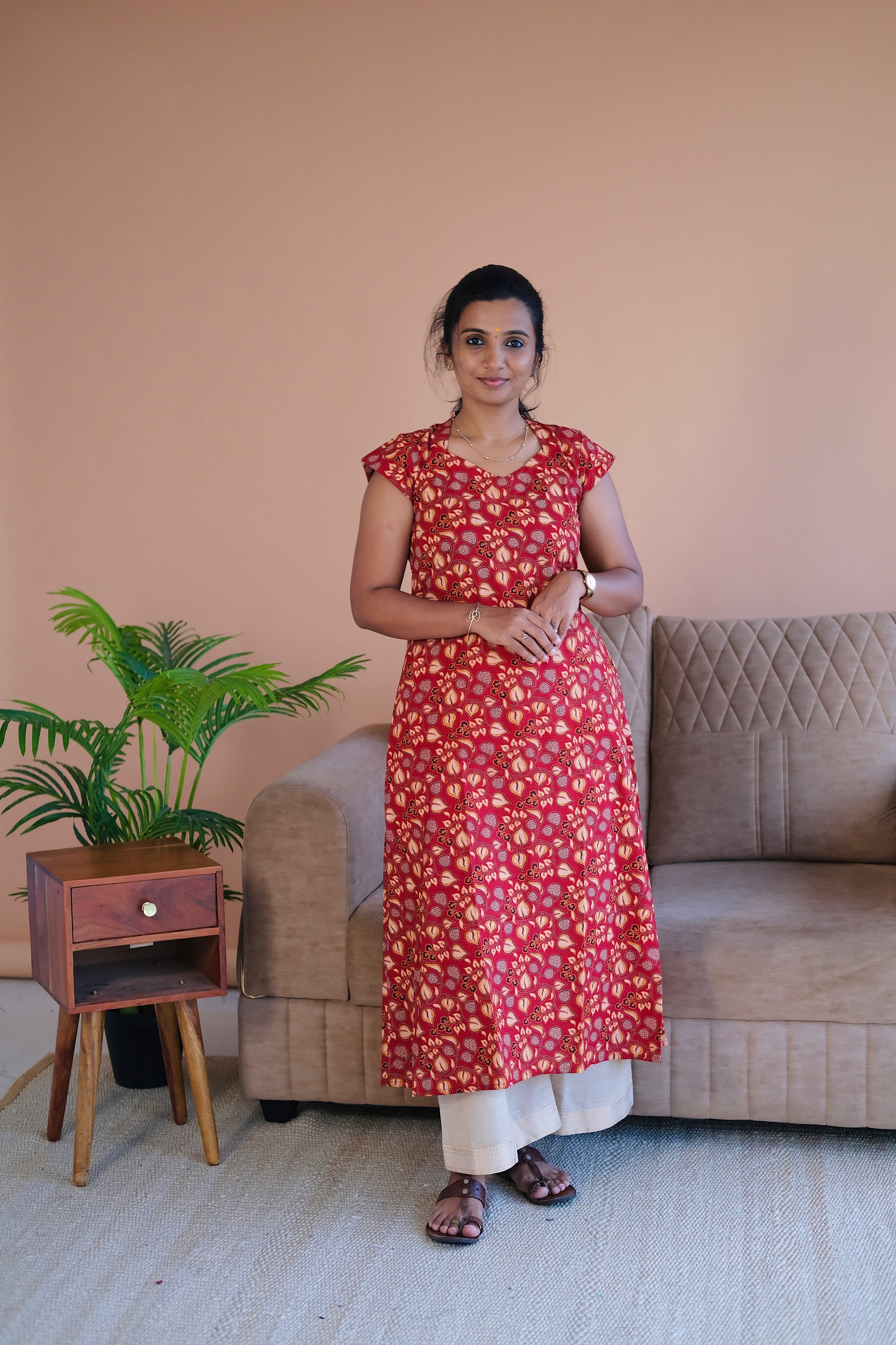 Front view of the red printed cotton a line kurti showing its relaxed fit