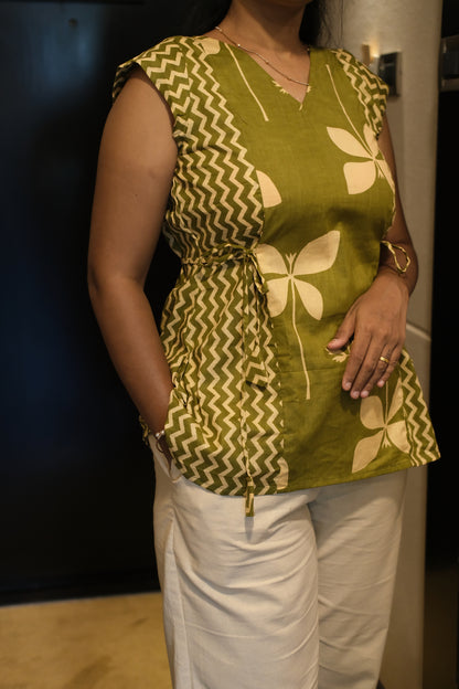 Close-up of olive green printed cotton top showing floral and zigzag patterns