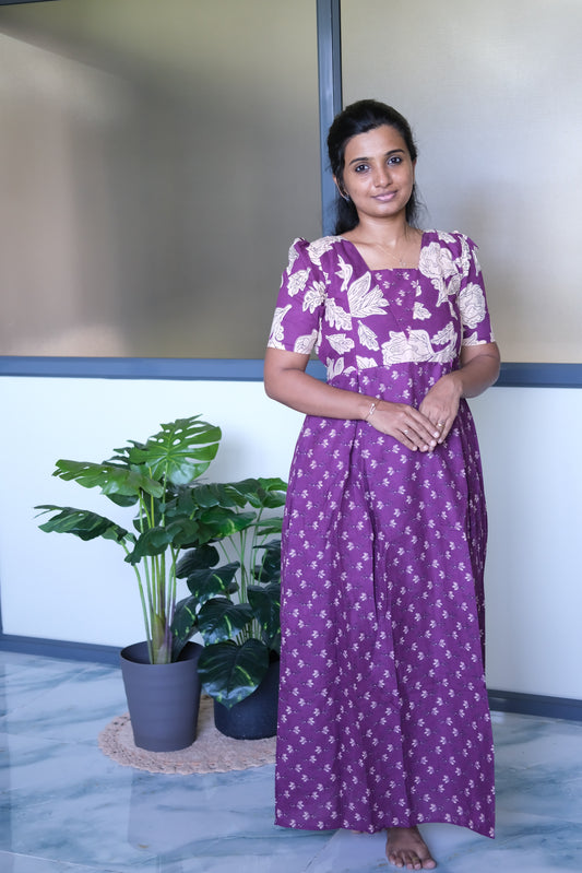 Purple ladies cotton nighty with dual floral prints, a square neckline, and short puff sleeves.