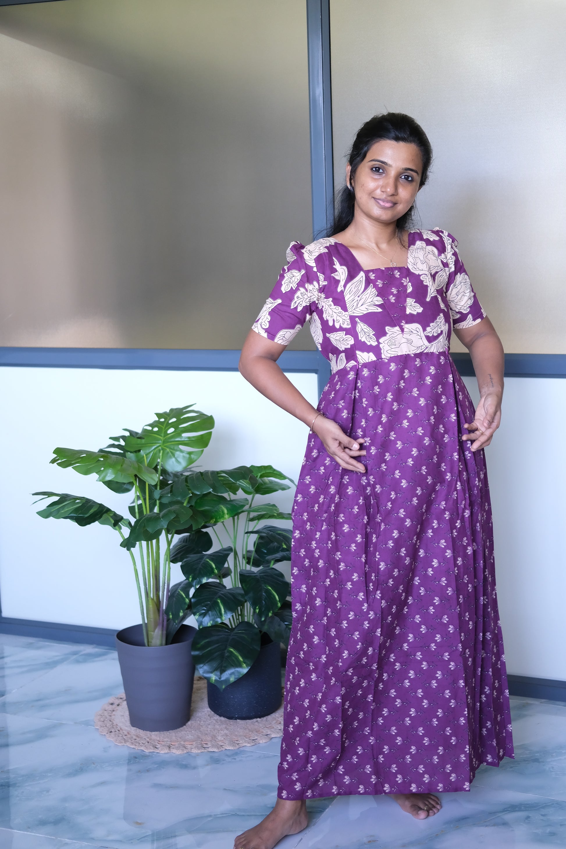 Full-length view of a purple cotton maxi nighty with a pleated waistline and relaxed flared skirt.