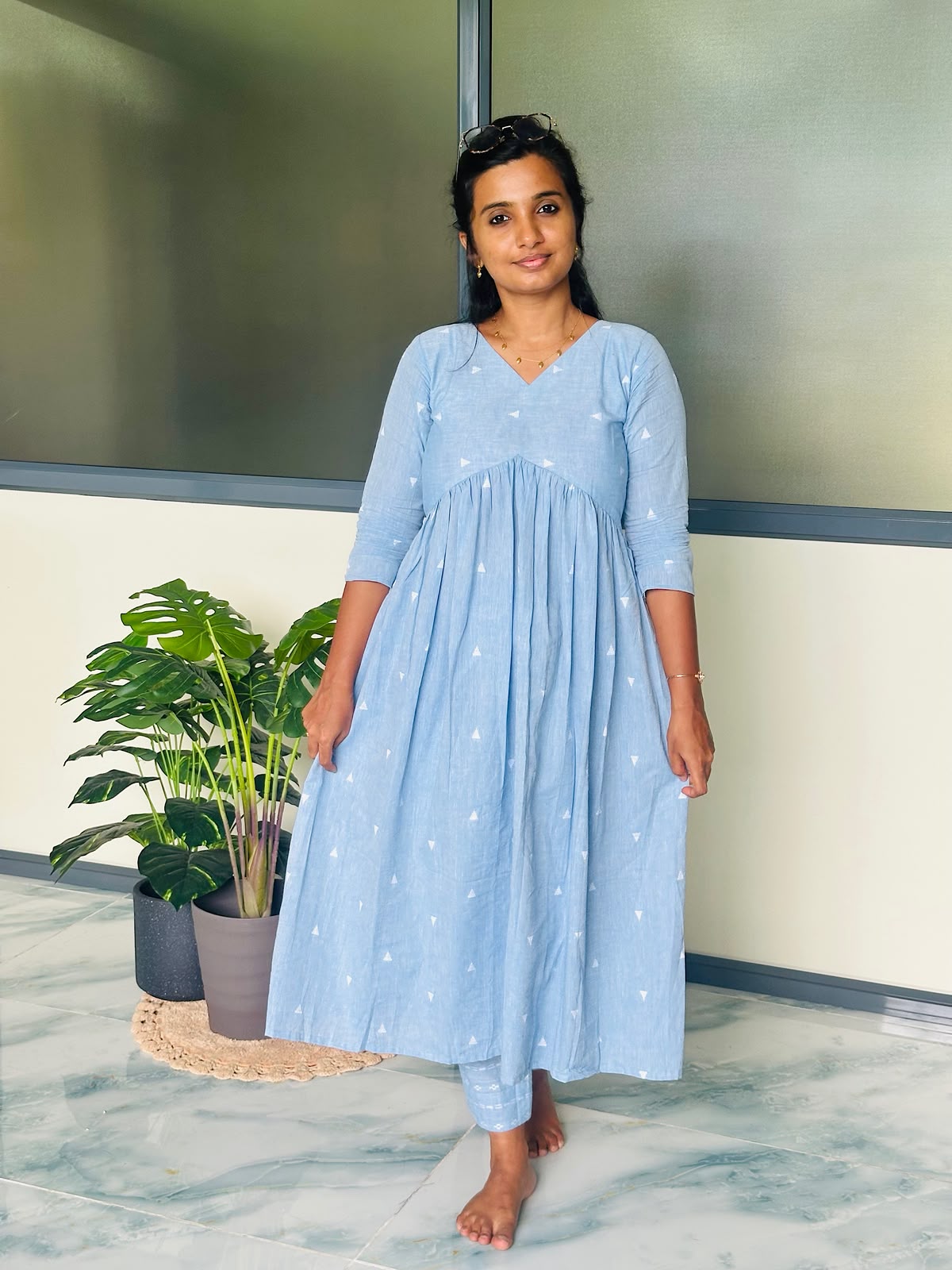Calf-length sky blue Alia cut kurti set with delicate white woven triangular motifs.