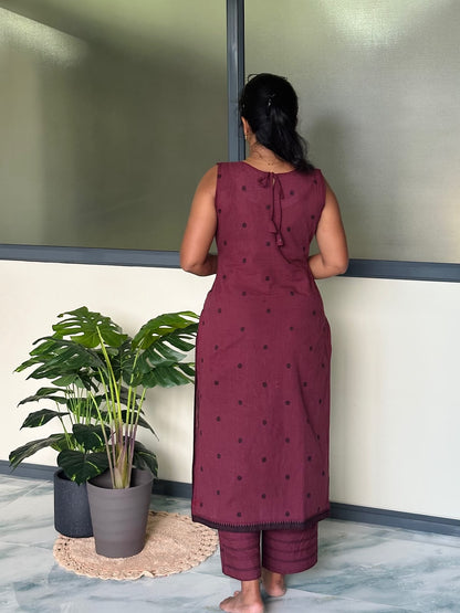 Back view of the burgundy reversible kurti set showing the tie-up neck detail and polka dot pattern.