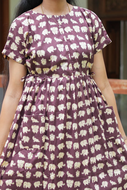 Close-up of the elephant print on the dusty plum cotton maxi nighty highlighting the adjustable waist tie-ups.