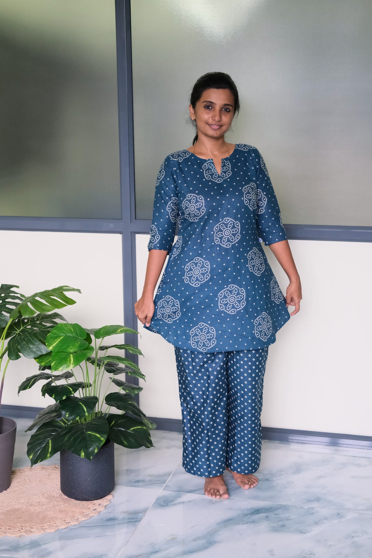 Front view of the dusty blue printed loungewear set showing the relaxed fit, curved hemline, and 3/4 sleeves.
