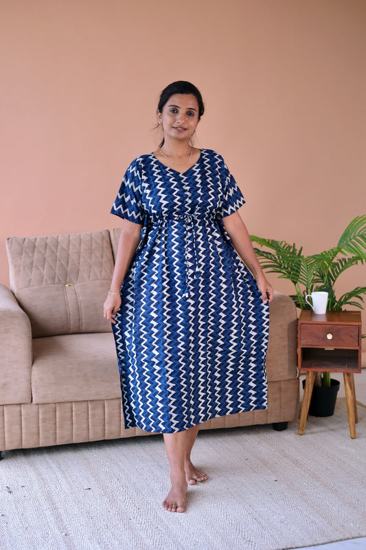 An indigo blue cotton kaftan nighty with a white zigzag print, featuring a V-neck and adjustable drawstring waist.