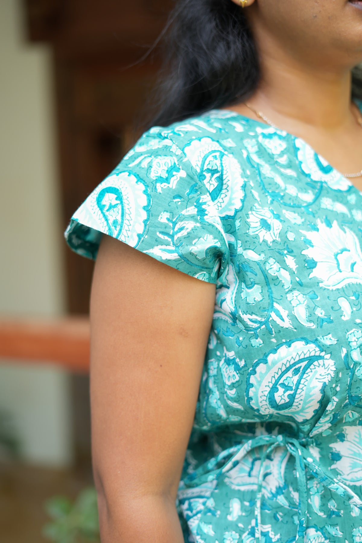 Close-up of cap sleeve and fabric detail on teal blue cotton nighty