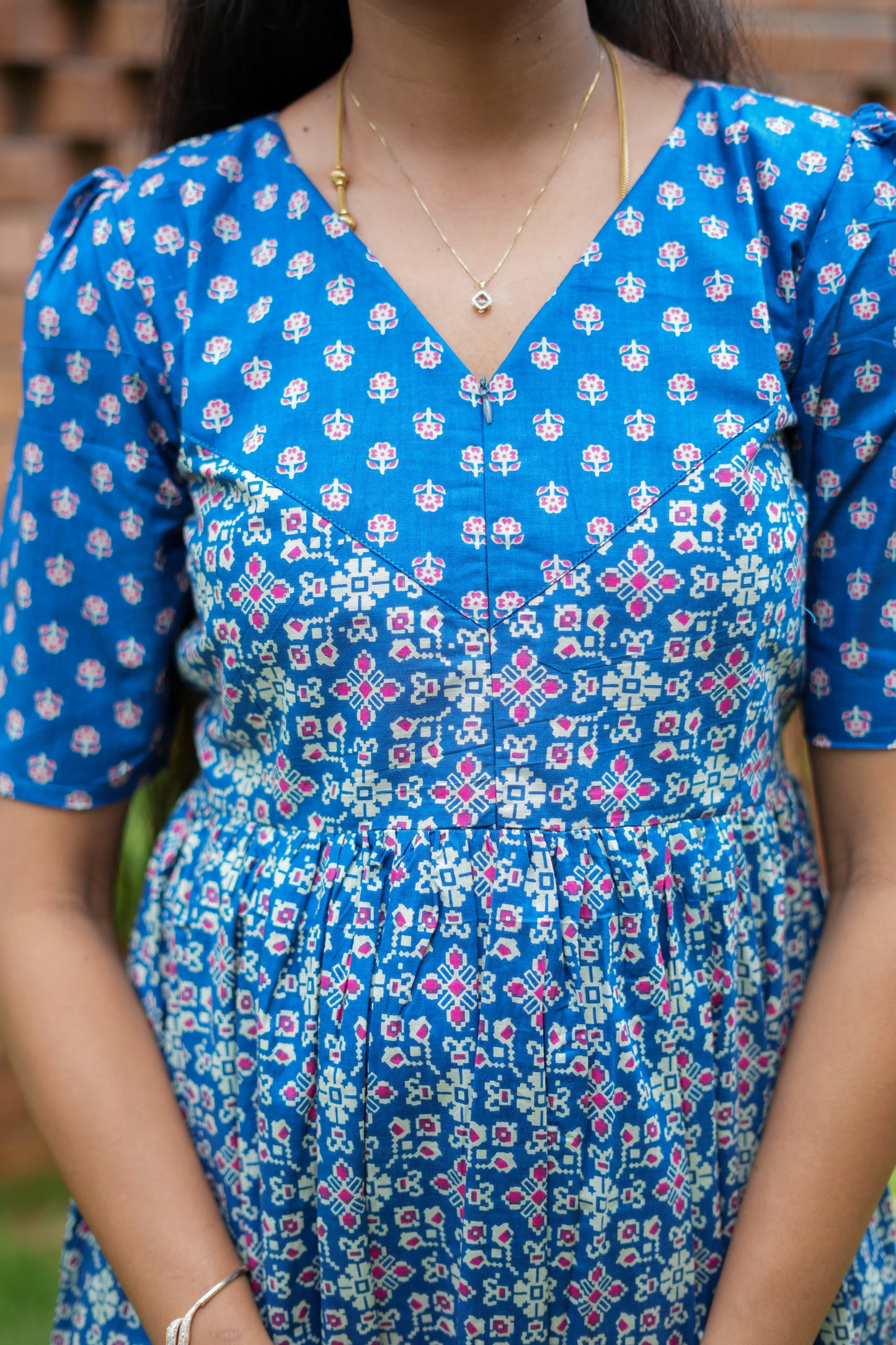 Close-up of the high neck and hidden feeding nighty with zip detail on the blue printed yoke