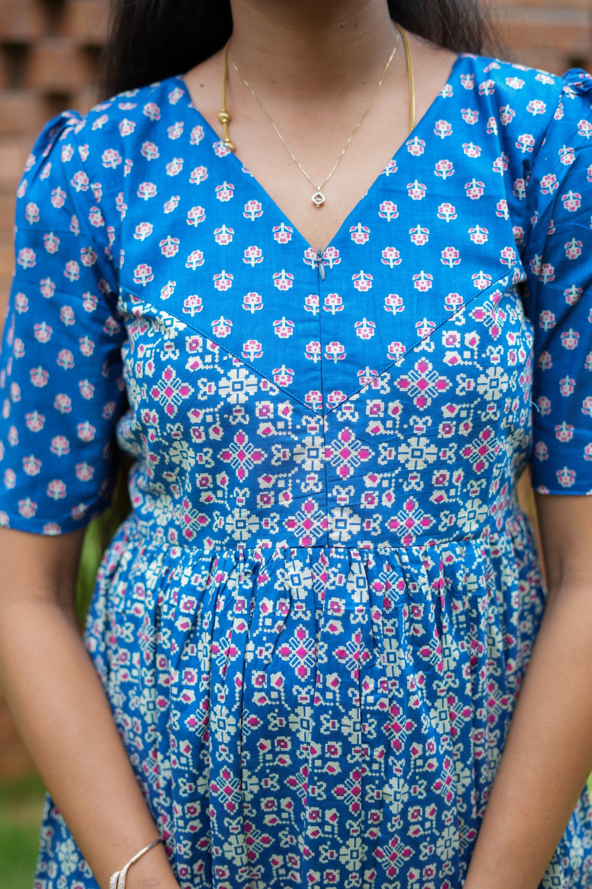 Close-up of the high neck and hidden feeding nighty with zip detail on the blue printed yoke