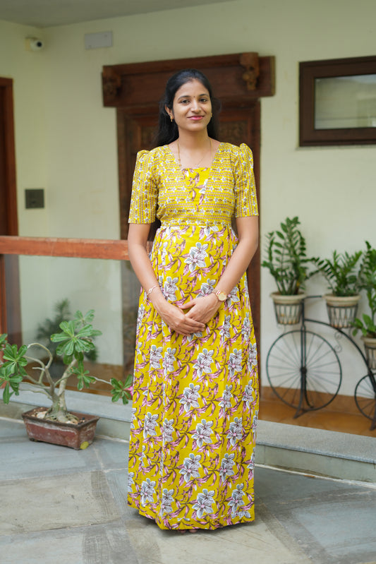 Mustard yellow cotton maxi nighty with dual floral prints and puff sleeves.