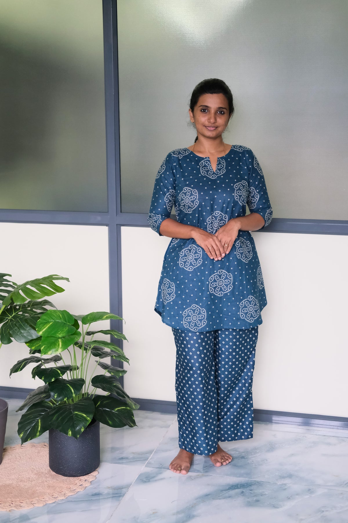 Dusty blue cotton night suit for women featuring a flared tunic top with white bandhani prints and matching straight-cut pants.