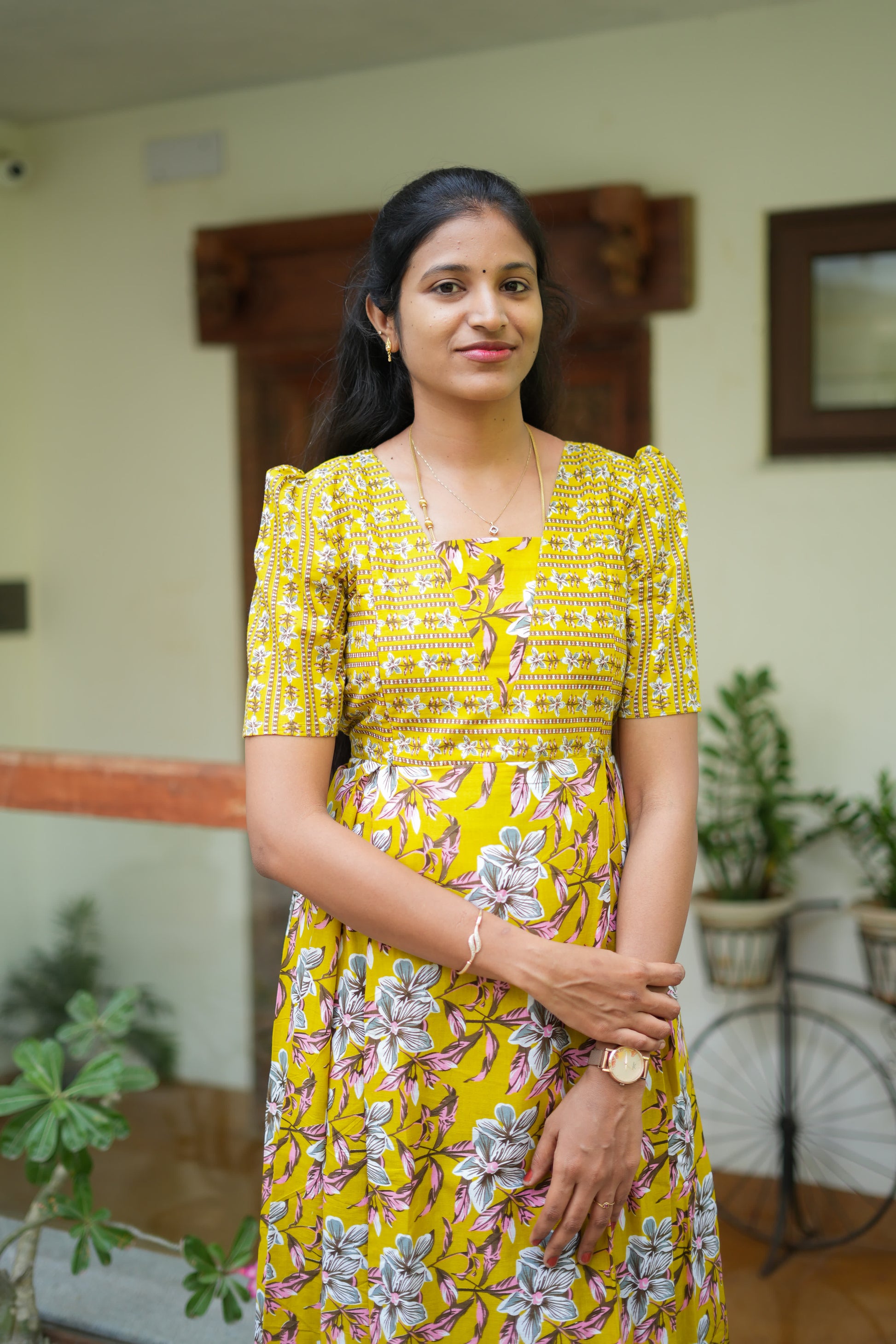 Close-up of the bodice on a mustard yellow cotton maxi nighty with striped floral patterns.