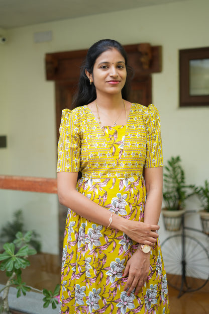 Close-up of the bodice on a mustard yellow cotton maxi nighty with striped floral patterns.