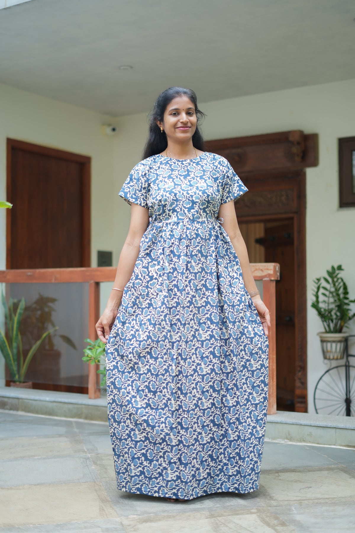Full-length view of a blue floral cotton maxi nighty with adjustable waist tie-ups