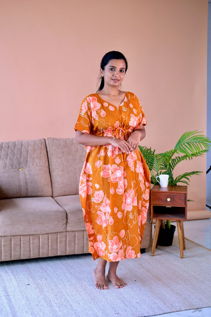 Midi nighty for women in rust orange cotton featuring a V-neck and relaxed kaftan sleeves.