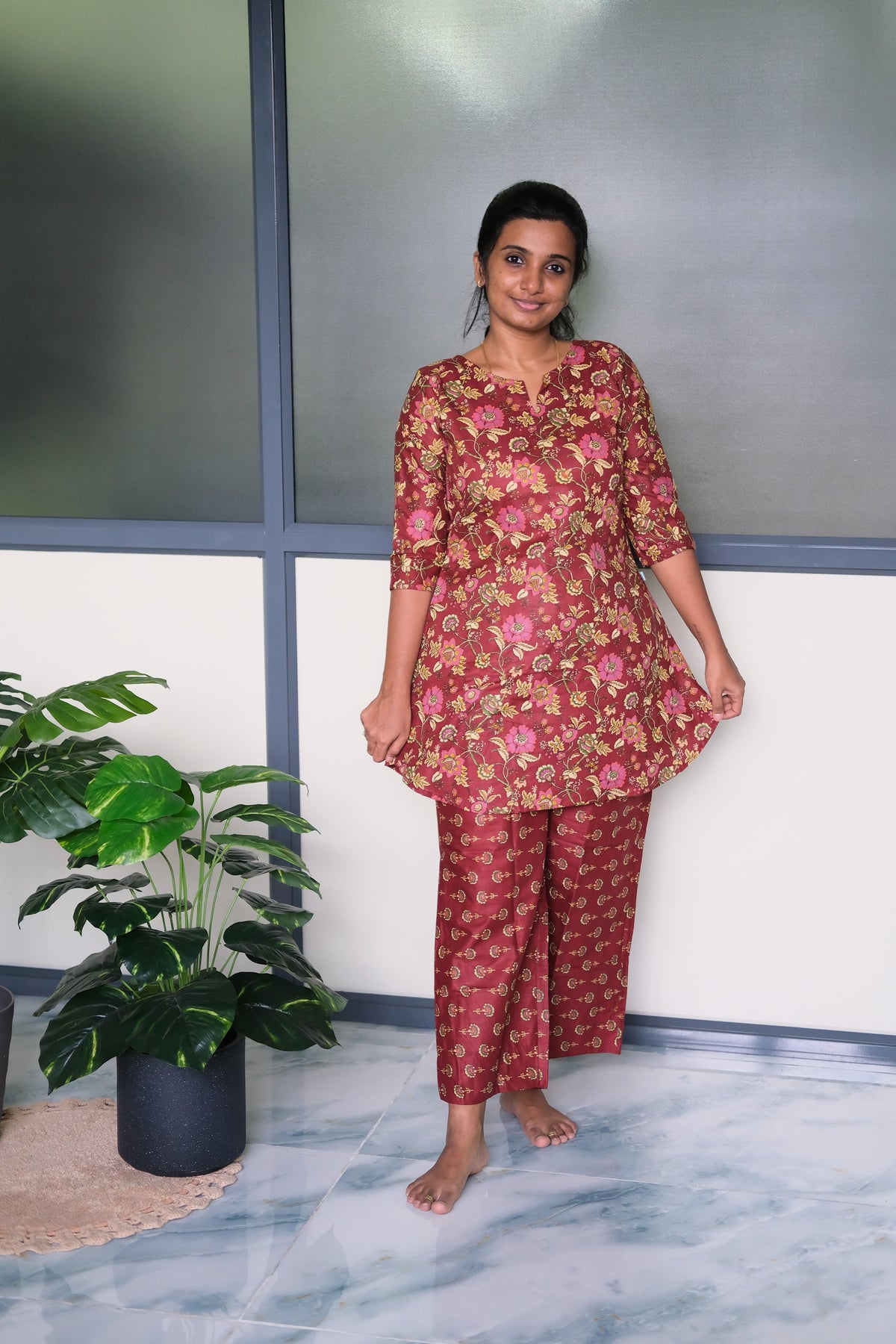Close-up of the floral print details on the wine red cotton night suit for women.