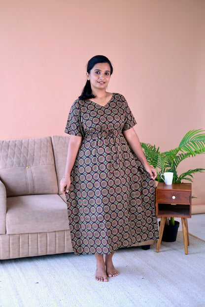 Midi-length cotton midi night dress in black and earthy tones showing the relaxed drape and V-neckline.