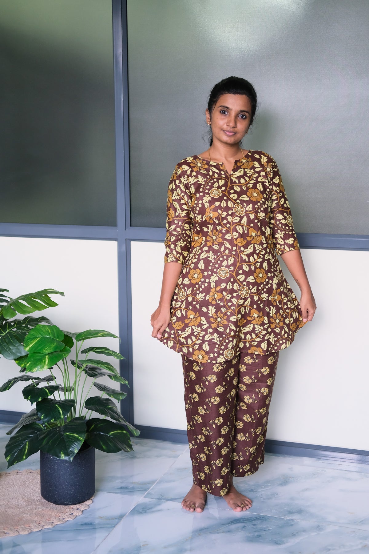 Model wearing a printed loungewear set in coffee brown cotton with a tunic-style top